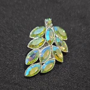 Iridescent green rhinestone brooch with an aurora borealis finish. 